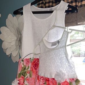 Two childrens place matching dresses